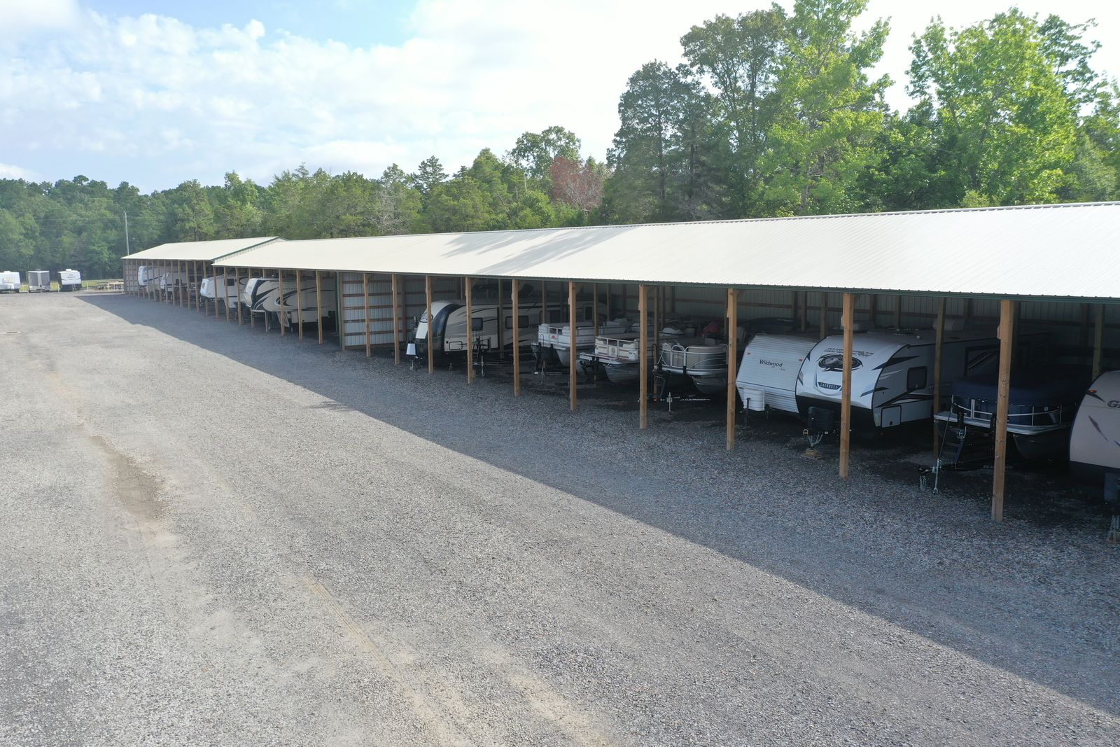 Covered boat and RV storage parking under open-sided shelter at Golden Anchor Storage